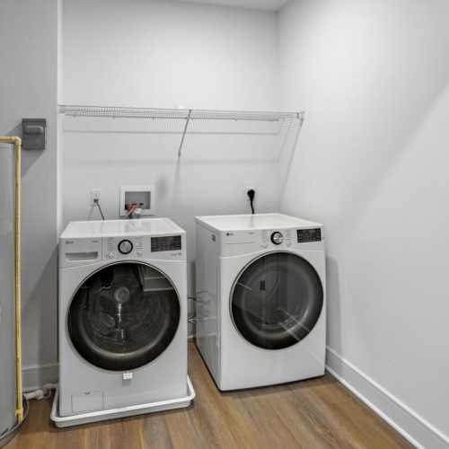 a room with a washing machine and a dryer