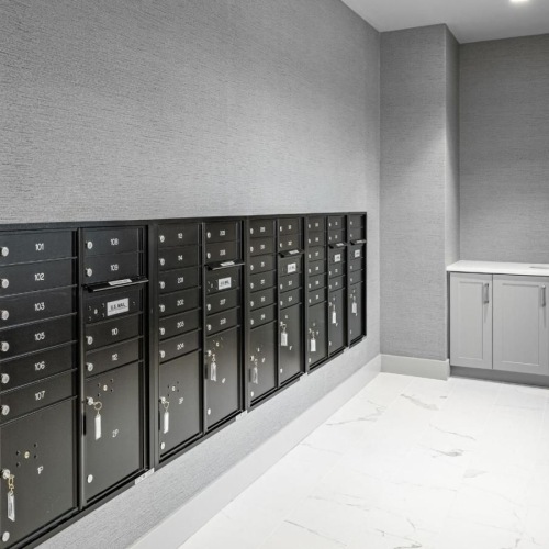 a room with a large wall of computer servers